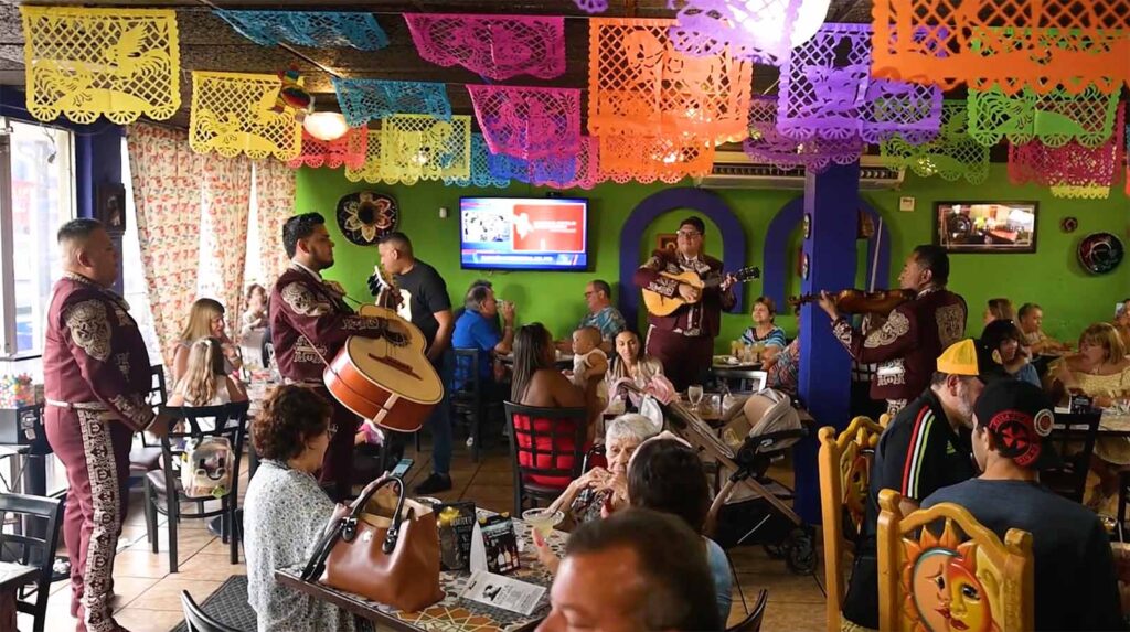 Mariachis playing a song inside the restaurant