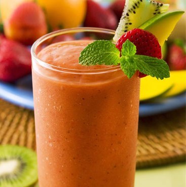 Glass of natural milkshake with fruits on top as decoration