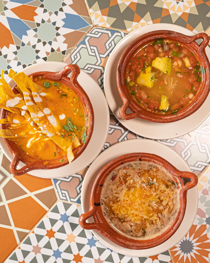 three mexican soups on a table