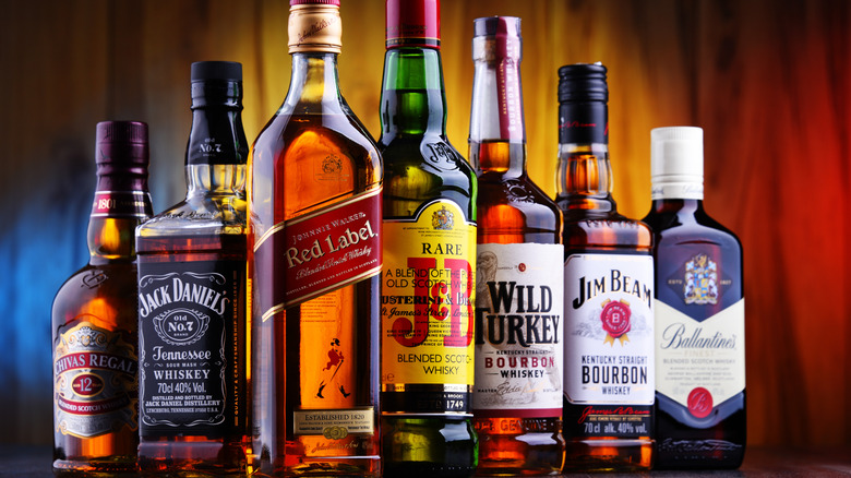 Multiple bottles of different brands of Whiskey